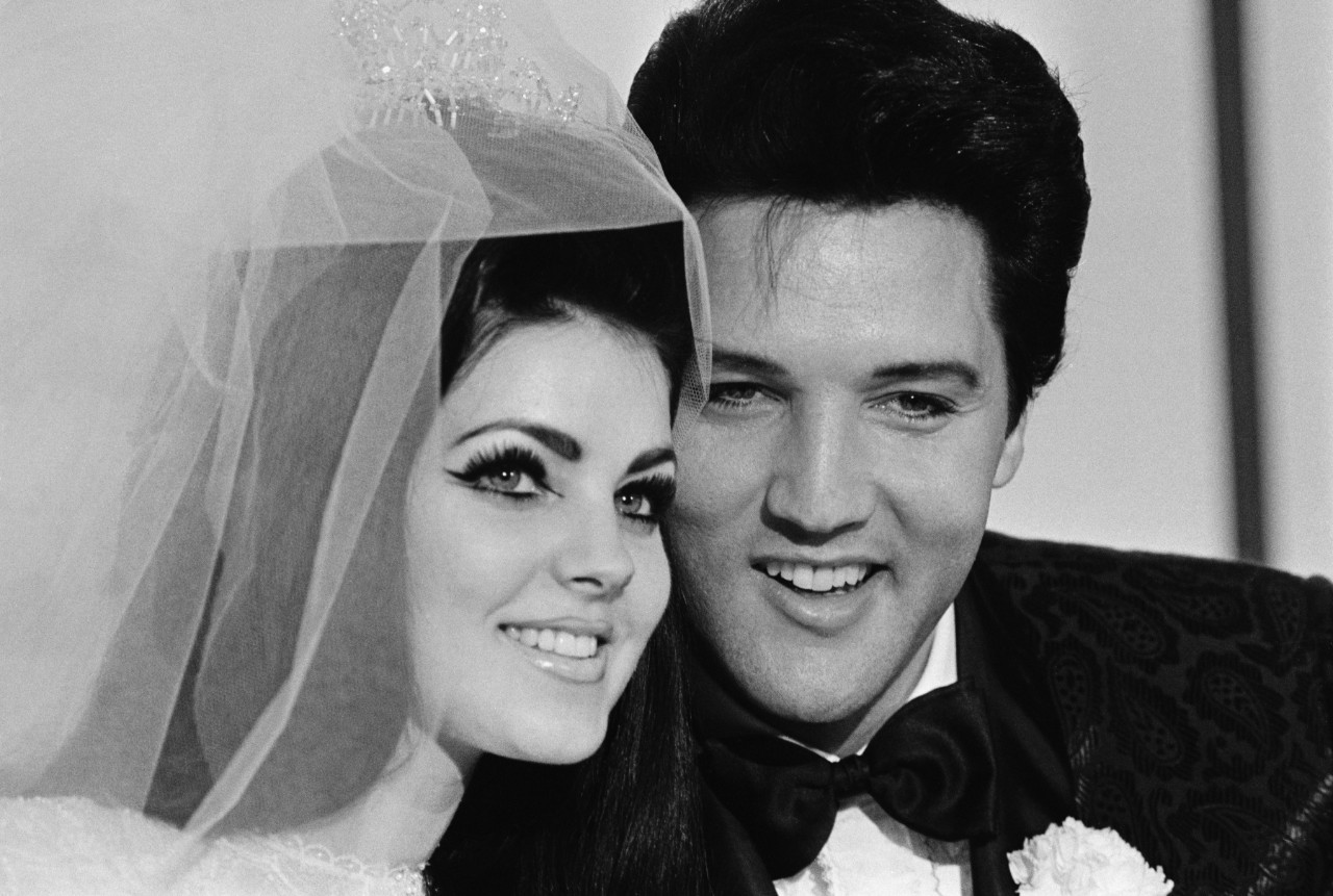 Original Caption: 5/1/1967-Las Vegas, NV-  Singer Elvis Presley and his bride Priscilla Ann Beaulieu, pose for photograph following their wedding at the Aladdin Hotel. Presley, 31, met his 22-year-old bride when he was stationed in Germany during his Army service.